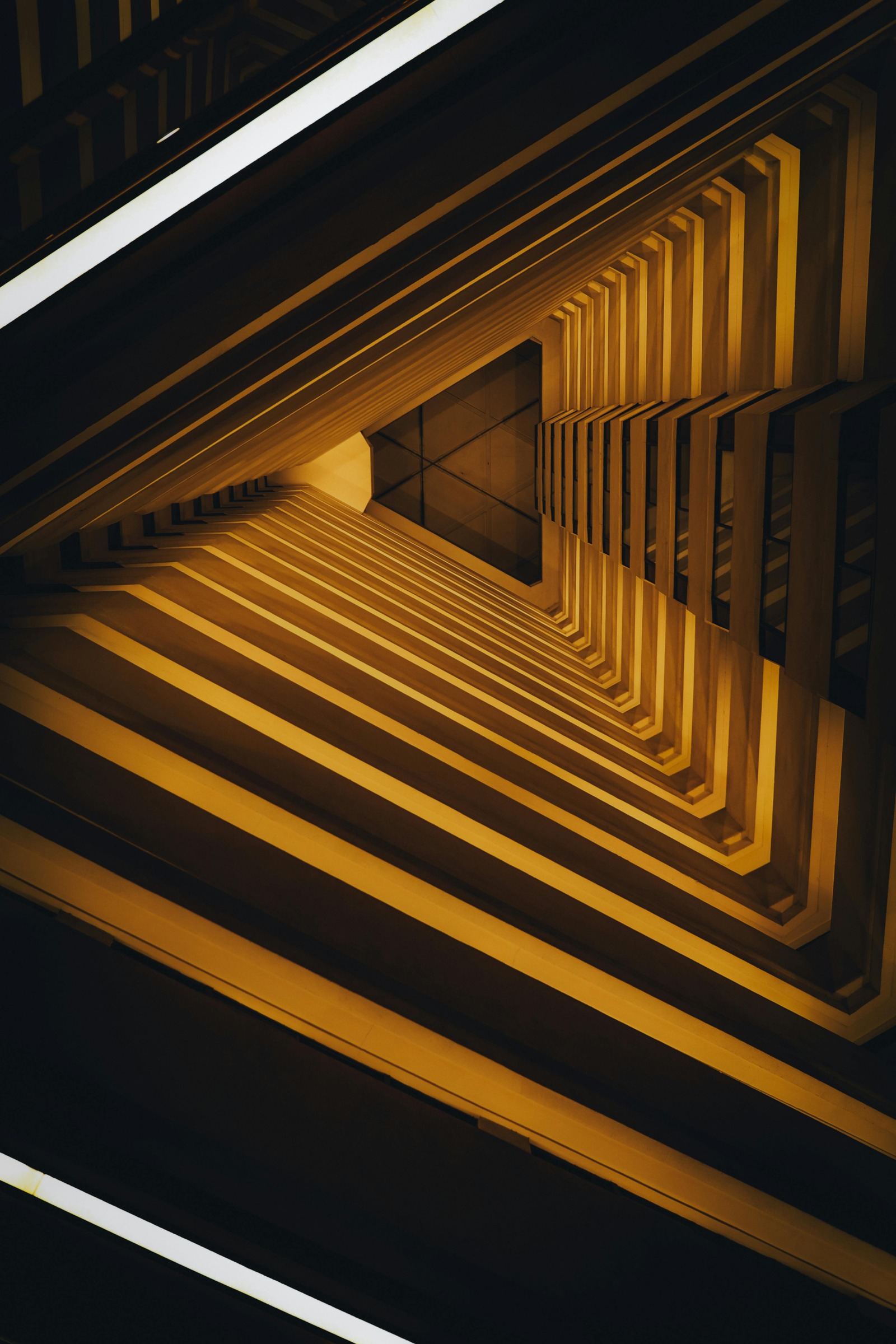 Golden light corridor receding into darkness