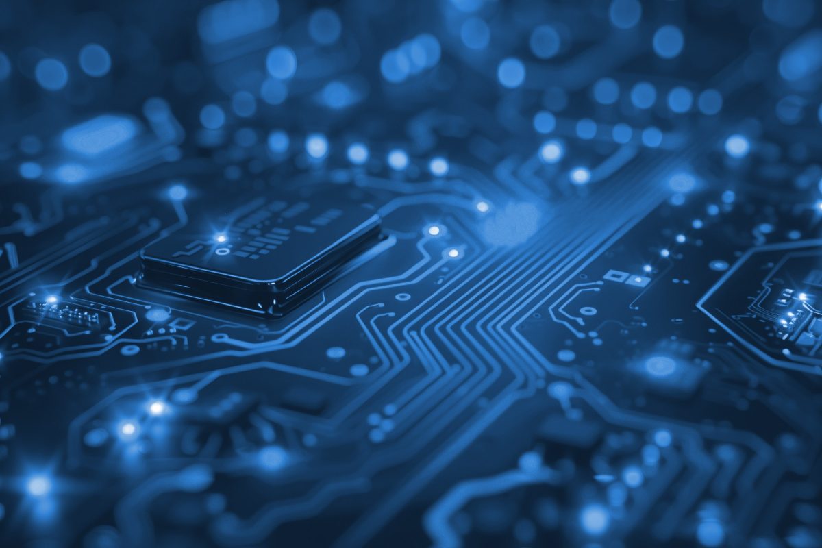 Close-up of a blue circuit board with illuminated traces